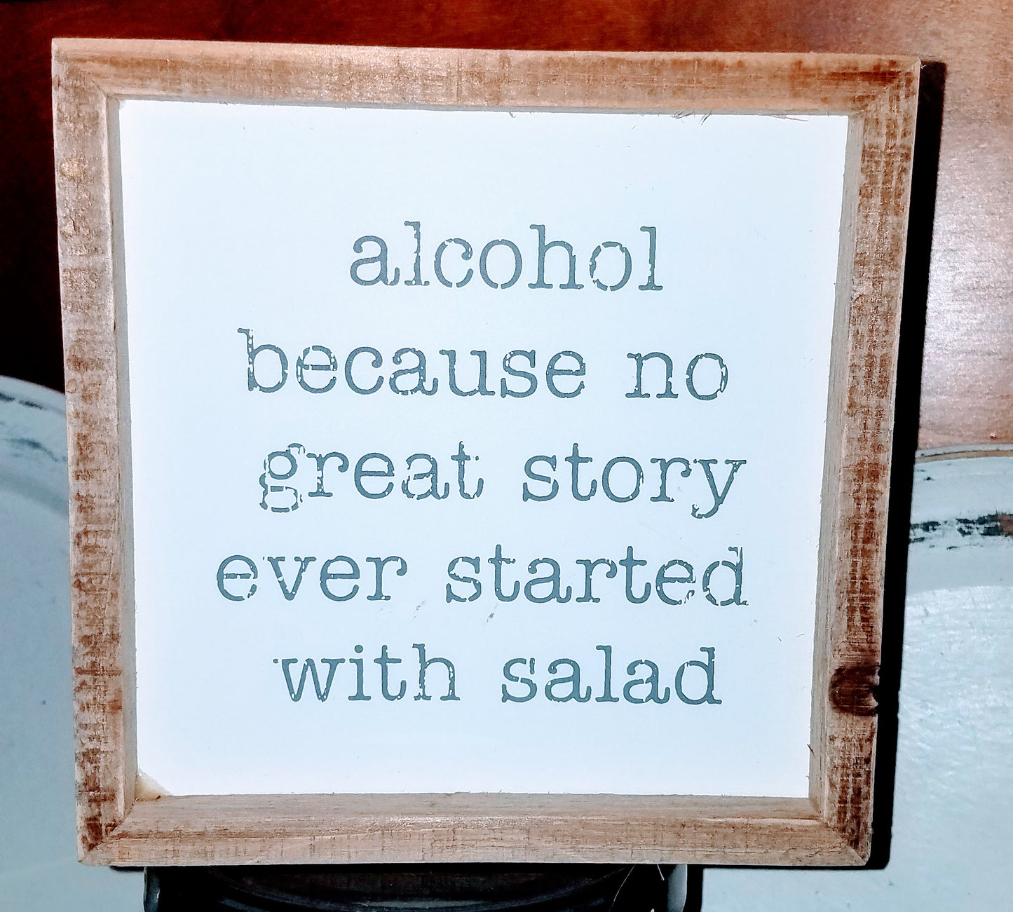 weathered wooden frame designed for rustic look with inset sign featuring funny text that reads "alcohol because no great story ever started with a salad