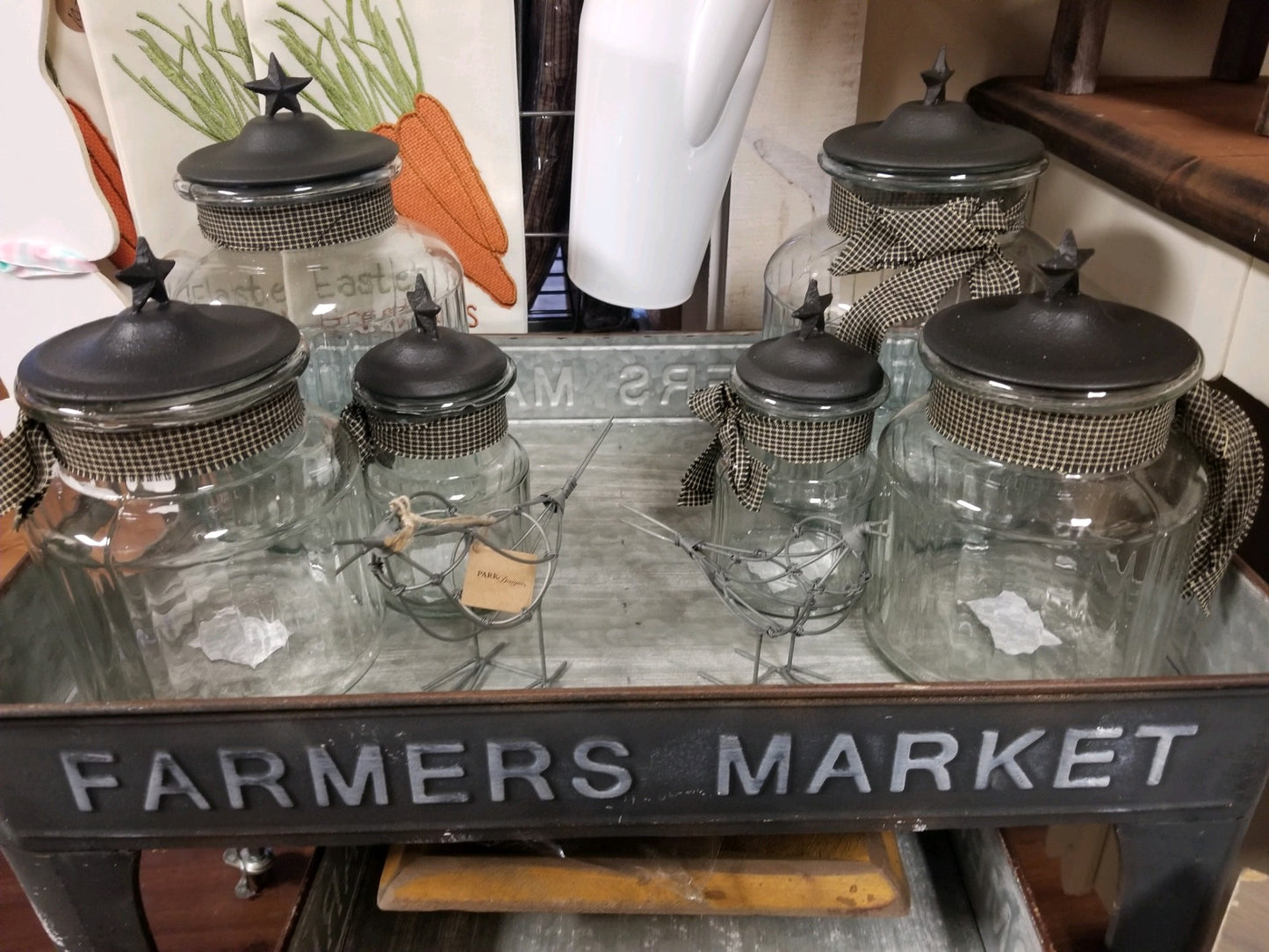 3 Glass jars with black metal cover with star on top for character. also ribbon tied around the neck as an accent that make it pop