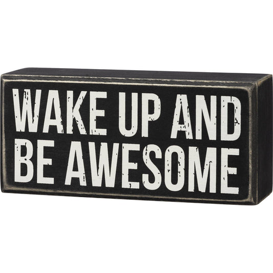 A classic wooden box sign featuring a "Wake Up And Be Awesome" sentiment.