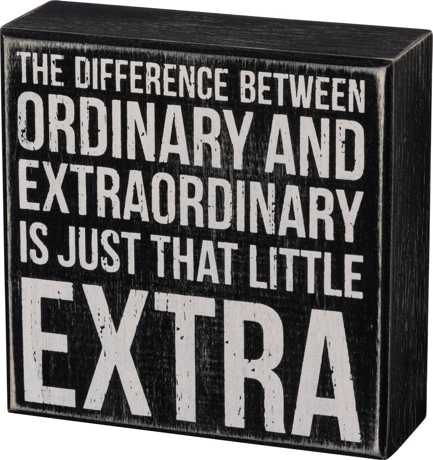 A classic black and white box sign featuring a distressed "The Difference Between Ordinary And Extraordinary Is Just That Little Extra" sentiment. 