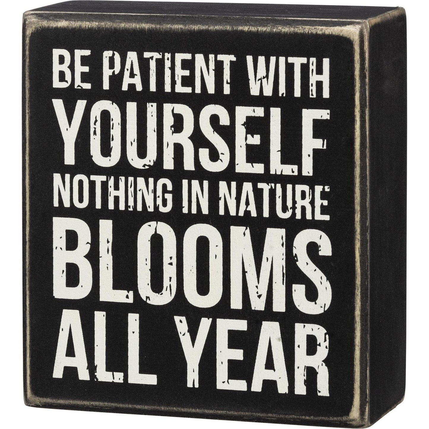 A classic wooden box sign featuring a "Be Patient With Yourself Nothing In Nature Blooms All Year" sentiment.