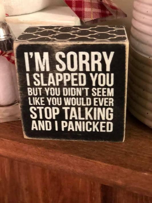 This Primitives by Kathy Box Sign is made of wood and can sit or hang. It reads "I'm sorry I slapped you but you did't seem like you would ever stop talking and I panicked." Primitives by Kathy is a leading producer of high quality decorative box signs and home decor.