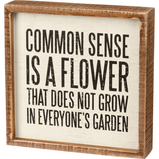 An inset box sign featuring a "Common Sense Is A Flower That Does Not Grow In Everyone's Garden" sentiment.