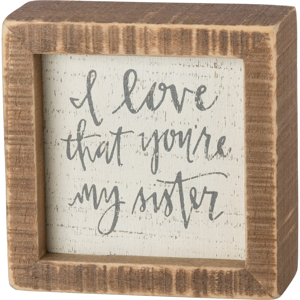 A wooden box sign lending an inset "I Love That You're My Sister" hand lettered sentiment. 