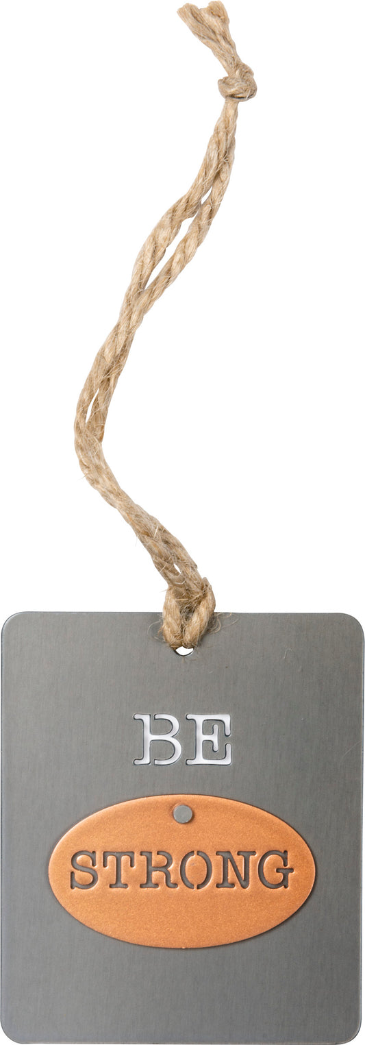 A metal ornament featuring a "Be Strong" sentiment. Contains a top wire loop for easy hanging.