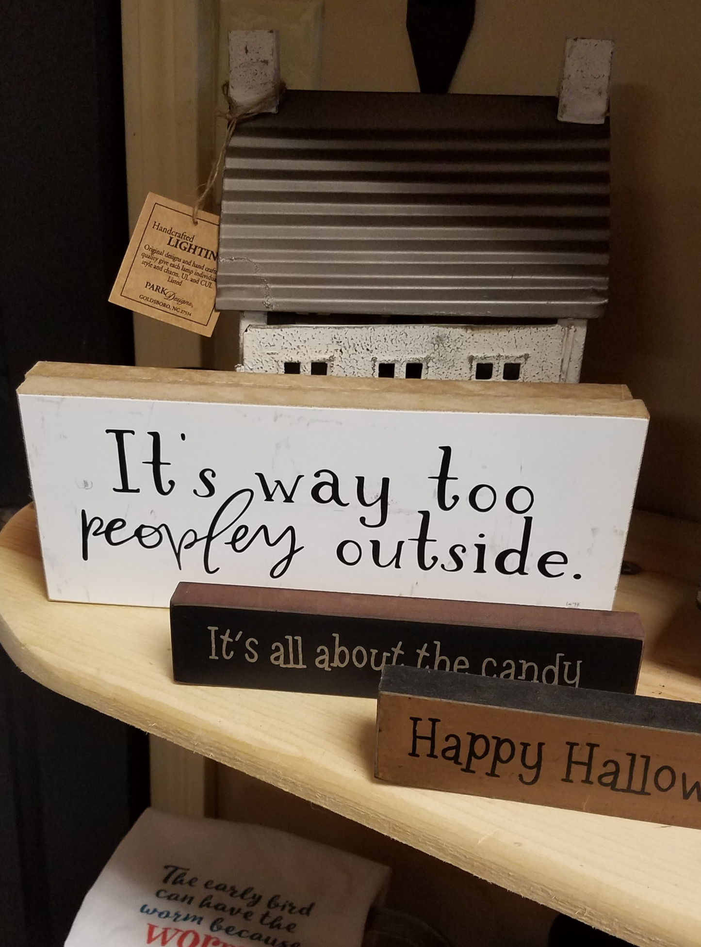 White background and black letters that read, "It's way too peopley outside". On piece of wood